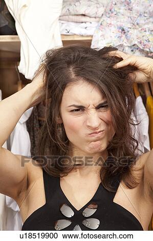 Stock Image - woman tearing her hair. Fotosearch