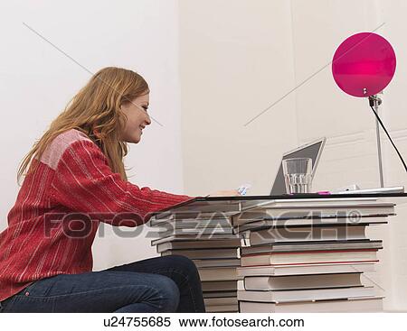 Woman using laptop, holding credit card View Large Photo Image Stock Photography - Woman using laptop, holding credit card. Fotosearch