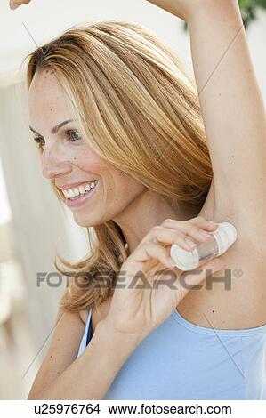 Woman Using Roll-on Deodorant View Large Photo Image Picture - Woman Using Roll-on Deodorant. Fotosearch