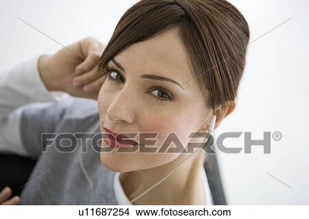 Woman wearing earphones. View Large Photo Image Picture - Woman wearing earphones.. Fotosearch