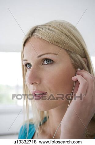 Stock Photo - Woman wearing earphones.. Fotosearch