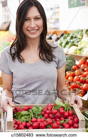 Woman with box of radish View Large Photo Image Stock Image - Woman with box of radish. Fotosearch