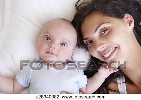 Woman with her baby, in bed View Large Photo Image Stock Image - Woman with her baby, in bed. Fotosearch