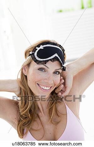 Stock Photography - woman with mask waking up. Fotosearch