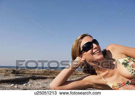 Woman With Sunglasses Relaxing On Beach View Large Photo Image Stock Image - Woman With Sunglasses Relaxing On Beach. Fotosearch
