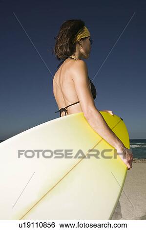 Stock Photograph - Woman with surfboard. Fotosearch