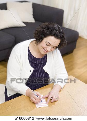 Woman writing a list. View Large Photo Image Stock Image - Woman writing a list.. Fotosearch