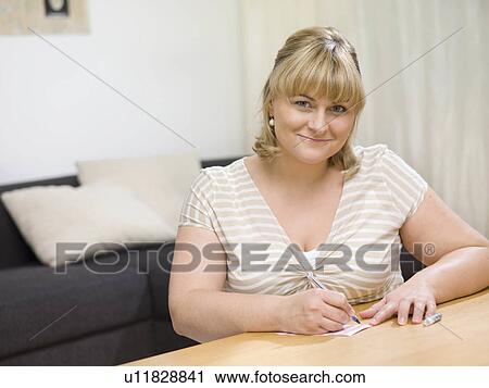 Stock Image - Woman writing a note.. Fotosearch