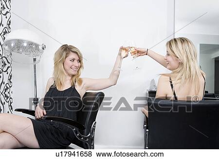 Stock Photo - women at hairdressers with champagne. Fotosearch