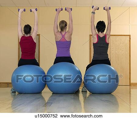 women exercising with weights at gym View Large Photo Image Stock Image - women exercising with weights at gym. Fotosearch