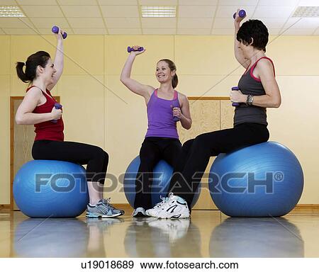 women exercising with weights at gym View Large Photo Image Stock Photo - women exercising with weights at gym. Fotosearch