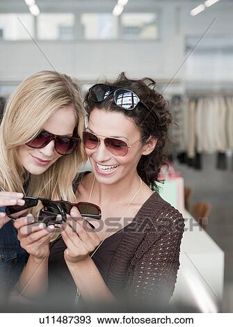 women shopping comparing sunglasses View Large Photo Image Stock Image - women shopping comparing sunglasses. Fotosearch