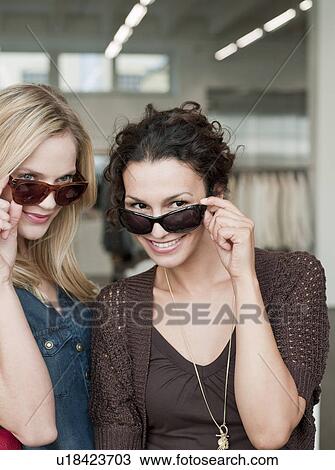 women shopping trying sunglasses View Large Photo Image Stock Image - women shopping trying sunglasses. Fotosearch