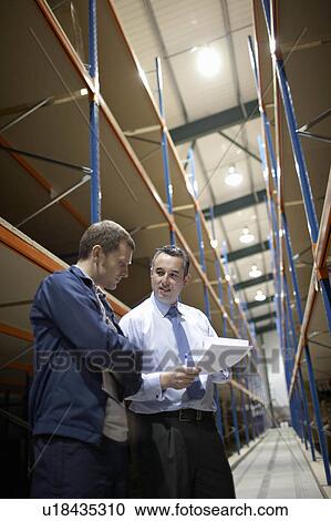 Worker and manager in warehouse View Large Photo Image Stock Image - Worker and manager in warehouse. Fotosearch