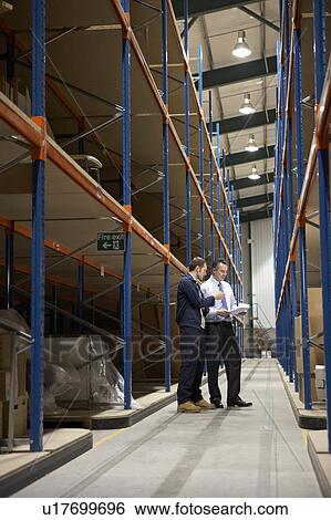 Stock Photograph - Worker and manager in warehouse. Fotosearch