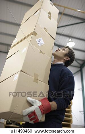 Worker carrying pile of boxes View Large Photo Image Stock Image - Worker carrying pile of boxes. Fotosearch
