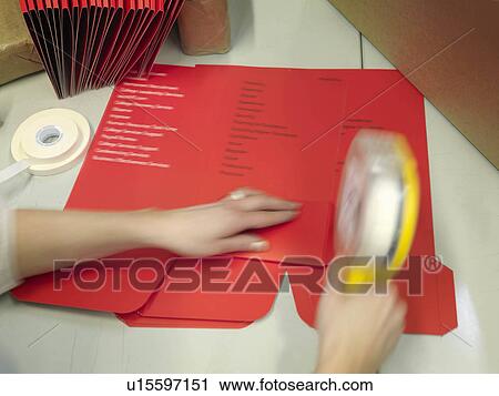 Stock Image - Worker Finishing Print Work By Hand. Fotosearch