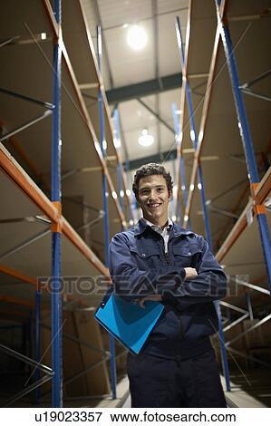 Stock Photo - Worker in warehouse, portrait. Fotosearch