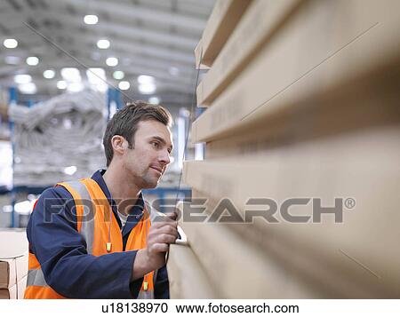 Worker Inspecting Product In Warehouse View Large Photo Image Stock Image - Worker Inspecting Product In Warehouse. Fotosearch