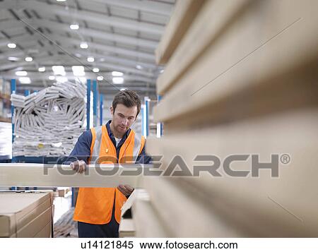 Worker Inspecting Product In Warehouse View Large Photo Image Stock Photography - Worker Inspecting Product In Warehouse. Fotosearch