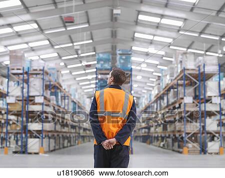 Worker Looking At Product In Warehouse View Large Photo Image Stock Photograph - Worker Looking At Product In Warehouse. Fotosearch