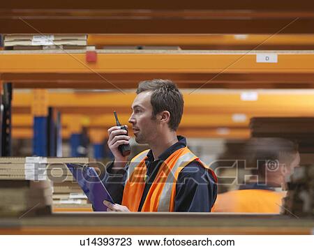 Worker On Walkie Talkie In Warehouse View Large Photo Image Stock Image - Worker On Walkie Talkie In Warehouse. Fotosearch