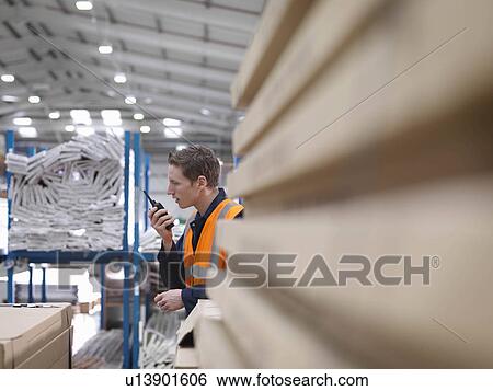 Worker On Walkie Talkie In Warehouse View Large Photo Image Stock Photograph - Worker On Walkie Talkie In Warehouse. Fotosearch