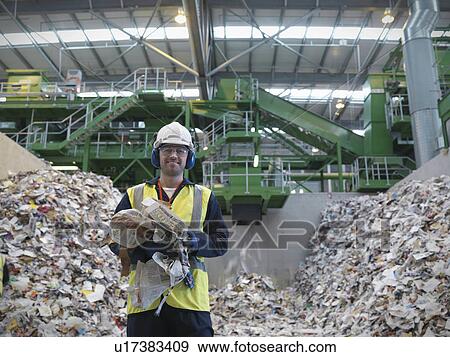 Stock Photo - Worker With Paper Being Recycled. Fotosearch