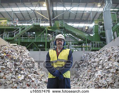 Stock Photograph - Worker With Paper Being Recycled. Fotosearch