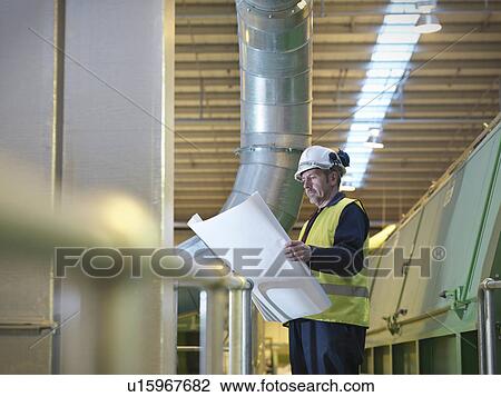 Worker With Plans In Plant View Large Photo Image Stock Image - Worker With Plans In Plant. Fotosearch