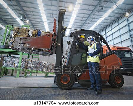 Picture - Workers And Forklift Truck In Plant. Fotosearch