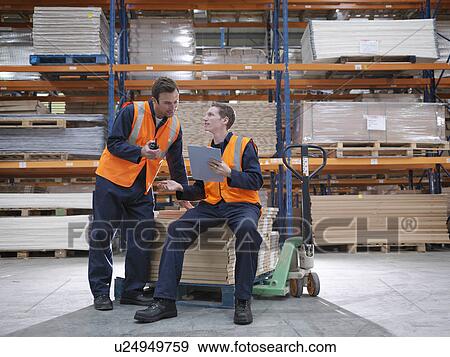 Workers Having A Discussion In Warehouse View Large Photo Image Stock Photo - Workers Having A Discussion In Warehouse. Fotosearch