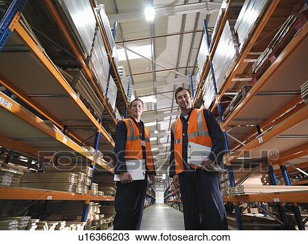 Workers In Aisle Of Warehouse View Large Photo Image Stock Image - Workers In Aisle Of Warehouse. Fotosearch
