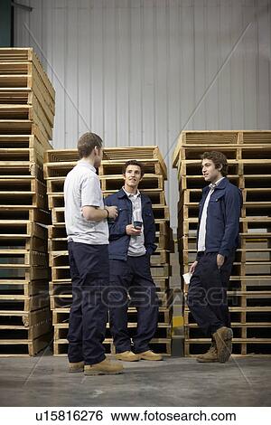 Stock Photograph - Workers in warehouse having break. Fotosearch