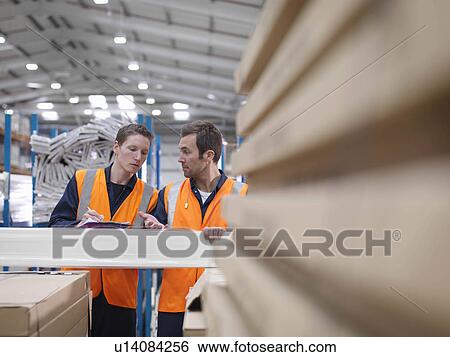 Workers Inspecting Product In Warehouse View Large Photo Image Stock Photograph - Workers Inspecting Product In Warehouse. Fotosearch
