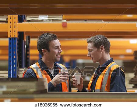 Stock Photography - Workers On Drink Break In Warehouse. Fotosearch