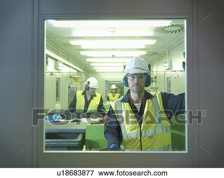 Stock Photo - Workers Separating Waste In Plant. Fotosearch