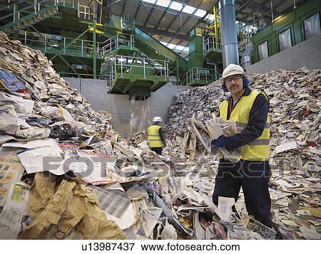 Stock Photo - Workers With Paper In Recycle Plant. Fotosearch