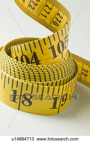 Stock Image - Yellow flexible tape measure. Fotosearch