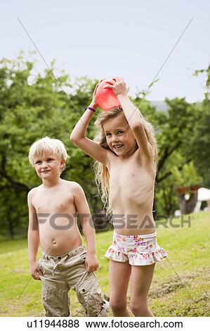Young Boy And Girl Playing in Garden View Large Photo Image Stock Photo - Young Boy And Girl Playing in Garden. Fotosearch