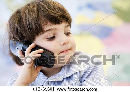 Stock Image - young boy phoning. Fotosearch