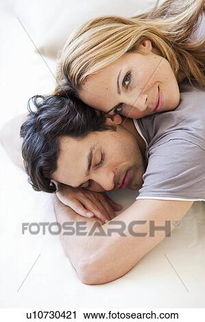 young couple snuggling in bed View Large Photo Image Stock Image - young couple snuggling in bed. Fotosearch