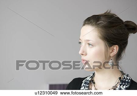 Young female looking to the left View Large Photo Image Stock Photo - Young female looking to the left. Fotosearch