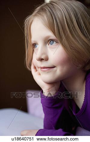 Stock Image - young girl daydreaming. Fotosearch