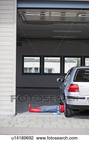 young girl lying under car cleaning View Large Photo Image Stock Image - young girl lying under car cleaning. Fotosearch