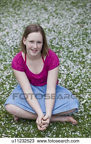young girl sitting in garden View Large Photo Image Stock Image - young girl sitting in garden. Fotosearch