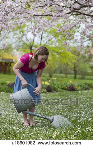 young girl watering grass View Large Photo Image Stock Image - young girl watering grass. Fotosearch