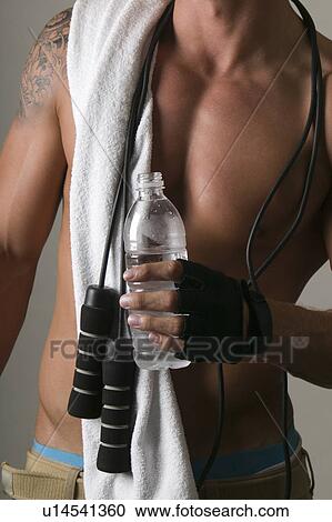 Young man in a gym View Large Photo Image Stock Image - Young man in a gym. Fotosearch