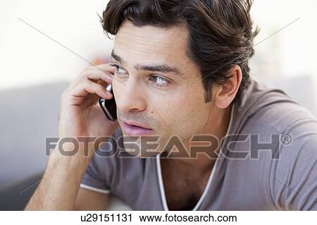 young man on cellphone View Large Photo Image Stock Image - young man on cellphone. Fotosearch