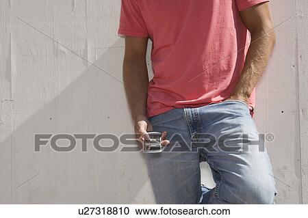 Stock Image - Young man with cell phone. Fotosearch